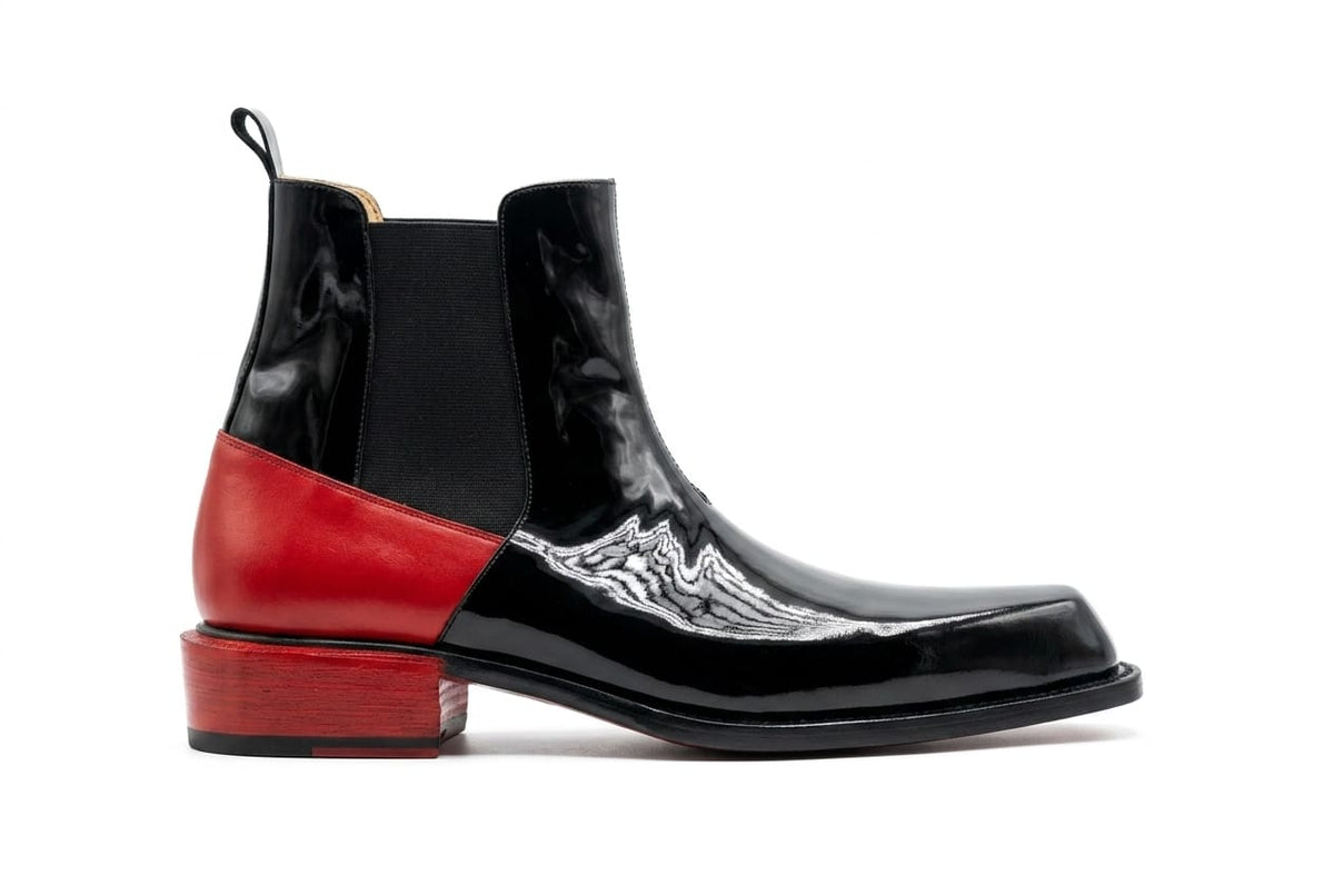Black and red ankle boots with a decorative pattern on a white background